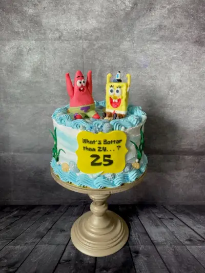 Underwater-themed cake with SpongeBob and Patrick figures, blue wave icing, and a sign reading What's Better than 24...? 25.