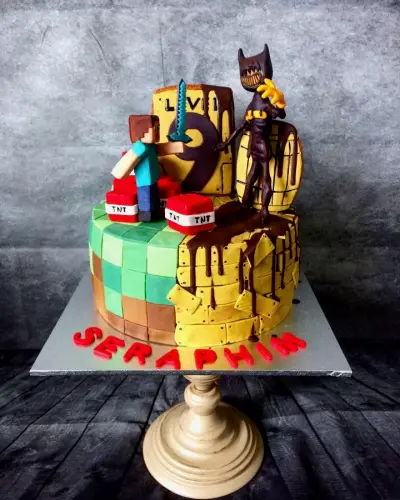 Minecraft-themed cake with pixel-block tiers, a TNT and sword scene, a dark creature figure and the name Seraphim.